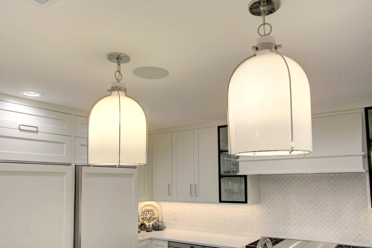 Two large pendant lights hang from the ceiling in this modern kitchen in North Dallas, Texas. 